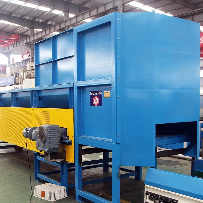 an Automatic Vertical Plastic Debaling Machine used in recycling facilities. This machine is designed to efficiently break down large bales of compacted plastic materials into looser forms that can be further processed and recycled. The debaling machine shown is robust, painted in blue and yellow for high visibility, and includes safety and operational signage. It features large blue housing that encloses the mechanical components necessary to separate the compacted materials, and a conveyor system integrated at the base to move the separated plastics to the next stage of the recycling process. This type of equipment is critical for handling and preparing bulk plastic waste for recycling, improving the efficiency of the recycling workflow.