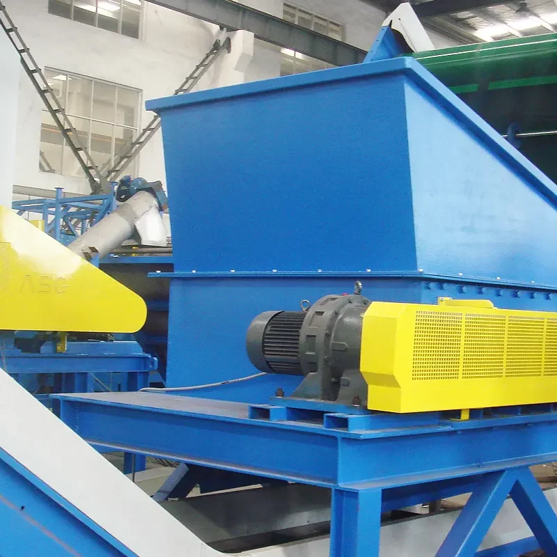 a horizontal debaler machine, primarily used in recycling facilities to break down and separate materials from baled plastic or paper products. The machine is robust, featuring a predominantly blue and yellow color scheme, which highlights its industrial nature. A large yellow motor and conveyor system indicate where the bales are processed and moved through the machine. The setup also includes protective housing and structural supports in blue, ensuring safety and durability. This machinery is essential for initial processing in recycling operations, preparing materials for further shredding or washing.