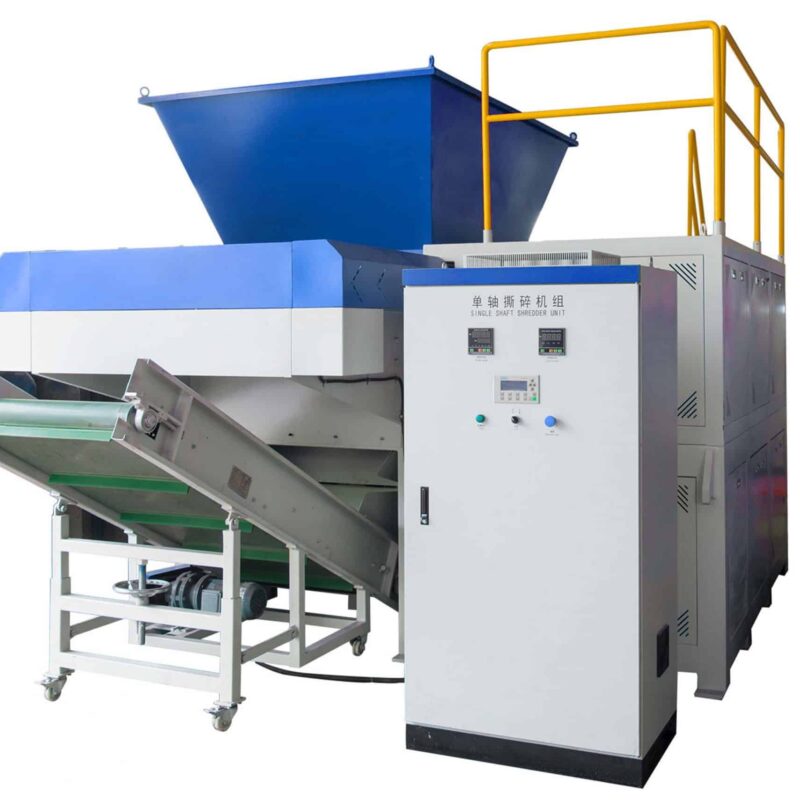 Industrial single shaft plastic shredder machine with large blue hopper, integrated control panel, and conveyor belt system on a white background.