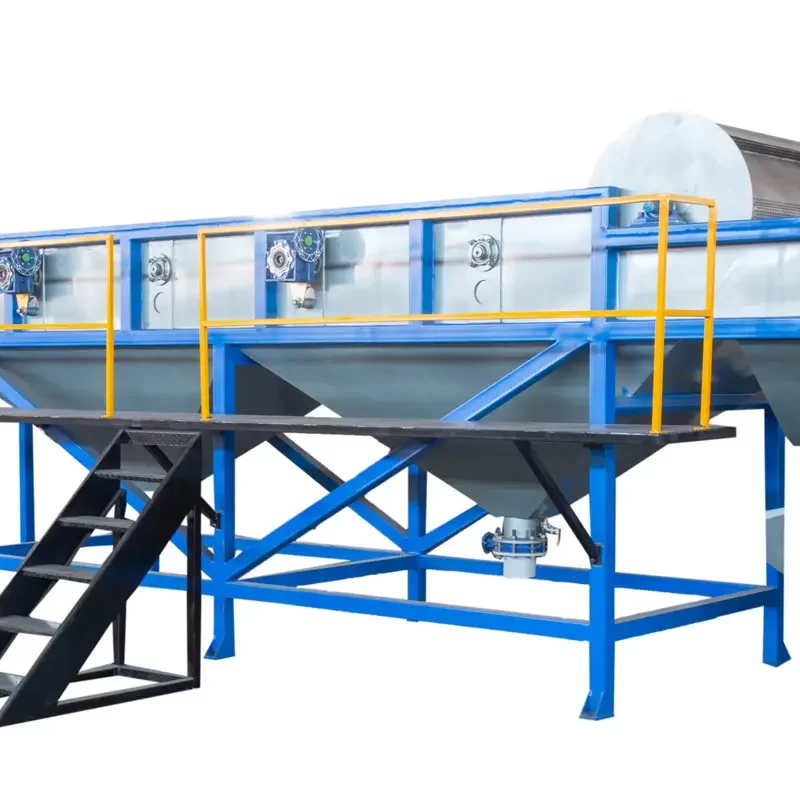 a plastic floating separation tank, an essential component in the recycling process for different types of plastics. This system utilizes the difference in density between various plastic materials to separate them in a water-based solution. The setup includes a large tank with a blue base and transparent sides, allowing for monitoring of the separation process. It is mounted on a sturdy blue and yellow metal framework with stairs for access. These tanks are crucial for effectively sorting plastics, which is a critical step in ensuring the purity and quality of recycled materials.