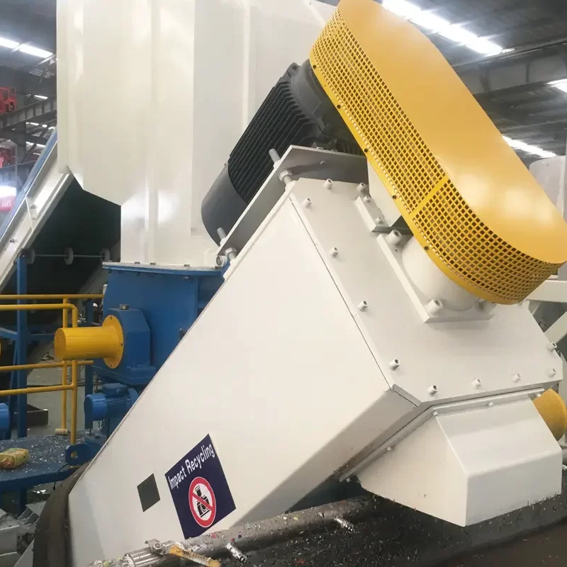 an industrial friction screw washer, a machine primarily used in the recycling process to clean plastic flake. This equipment works by using mechanical friction and water to remove contaminants like dirt, labels, and adhesives from plastic materials. The friction screw washer in the image features a robust design, with a large inclined screw enclosed in a housing. The housing is primarily white, with a yellow protective cover over the motor, enhancing safety and visibility in an industrial setting. Such washers are essential components in recycling facilities, ensuring that plastic flakes are thoroughly cleaned before they proceed to the next stages of recycling, such as melting and pelletizing.