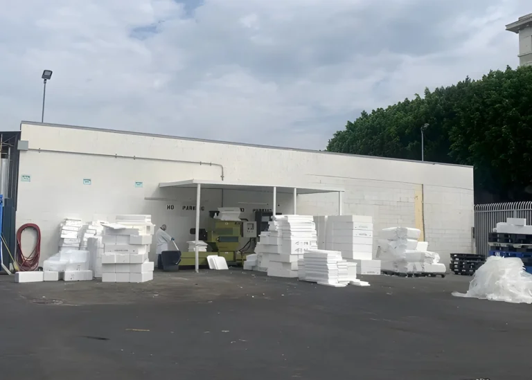 Warehouse with stacked white materials outside.