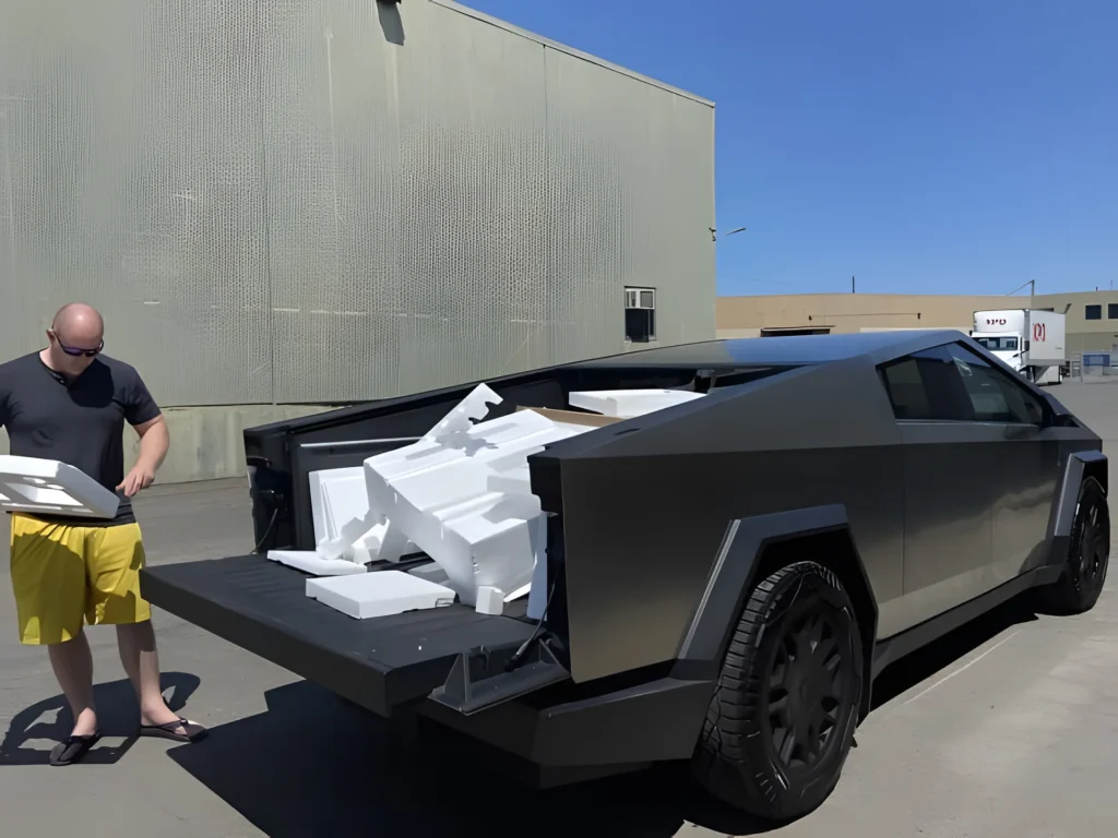 Man unloading packaging from Cybertruck.